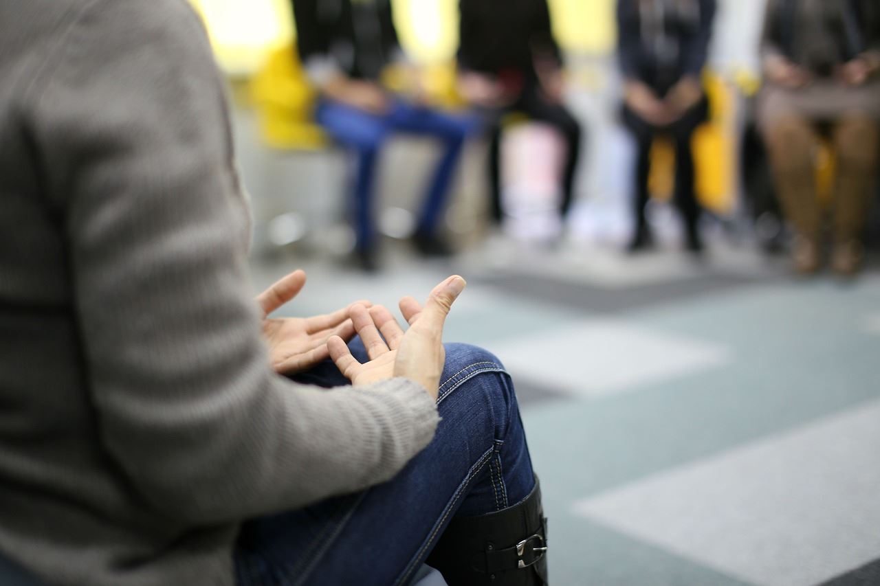 showing the hands of a speaker in a group circle